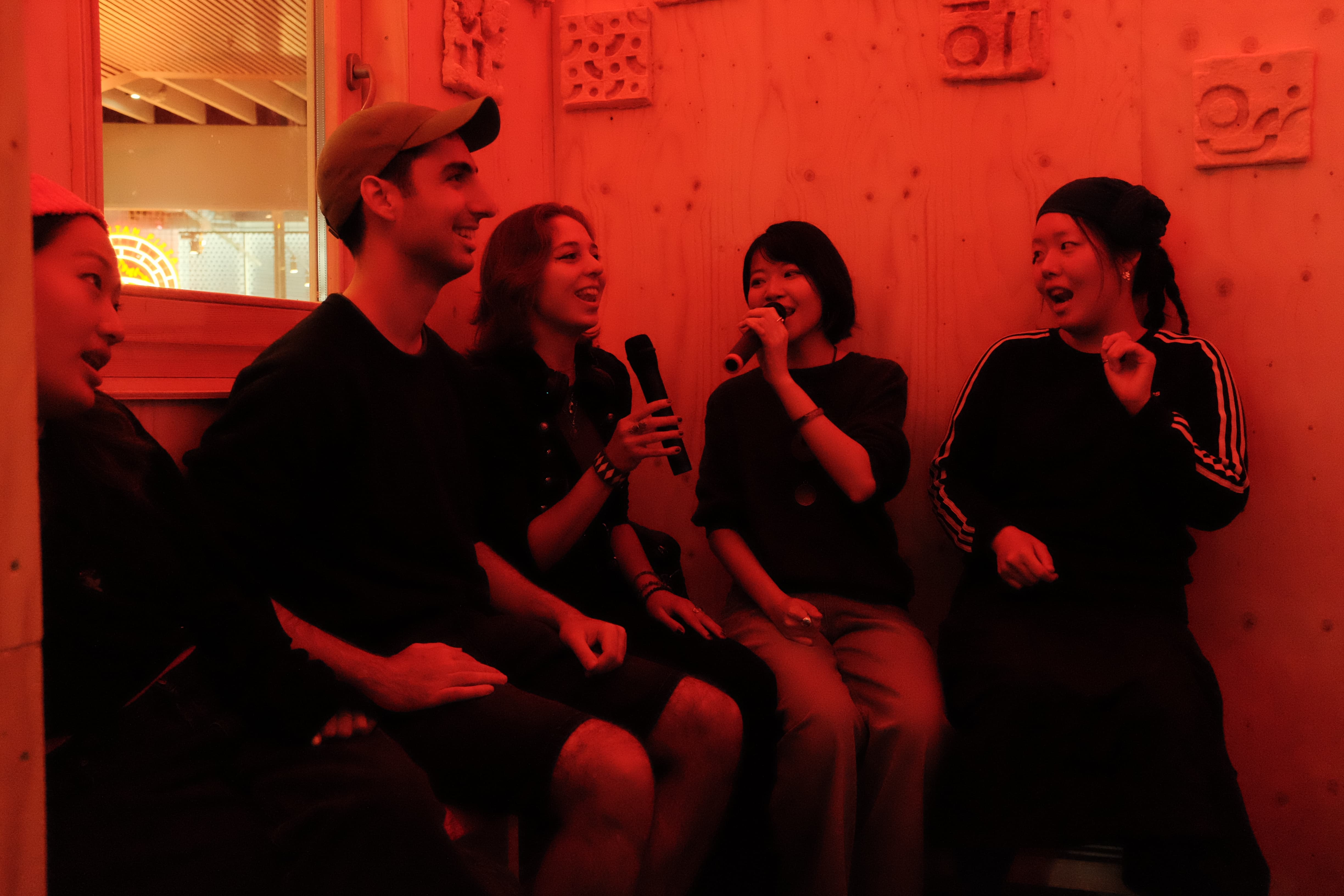 People singing inside the booth.